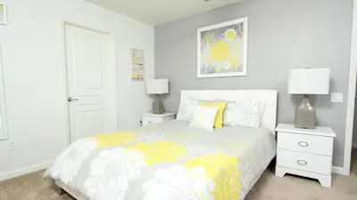 a bedroom with a bed and two night stands with lamps at Luxury 6 BR in Windsor Hill Resorts in Orlando