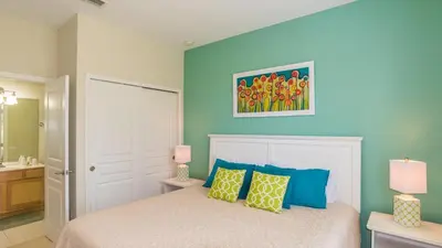 a bedroom with a bed with blue walls at Lavish 4BR Home in Windsor Hills Resort in Orlando
