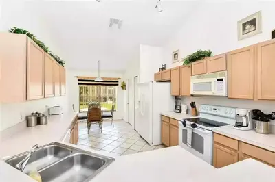 a kitchen with a sink and a stove top oven at Disney area 4-bedrooms spacious villa for rent in Kissimmee