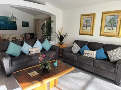 a living room with two couches and a coffee table at Disney area 4-bedrooms spacious villa for rent in Kissimmee