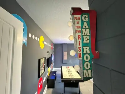 a room with a table and a sign on the wall at Luxury 6BD Encore Resort Disney Pvt Pool Game Room Near Disney Water Park in Orlando