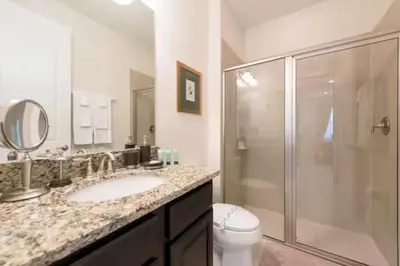 a bathroom with a shower and a sink and a toilet at Luxury 6BD Encore Resort Disney Pvt Pool Game Room Near Disney Water Park in Orlando