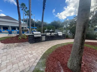 two parking meters in a brick wall next to a tree at Disney Accessibility Star Wars Vacation Apartment Near Parks in Orlando