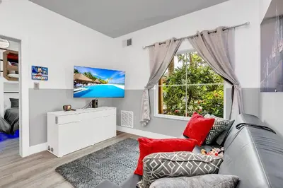 a living room with a couch and a window at Disney Accessibility Star Wars Vacation Apartment Near Parks in Orlando