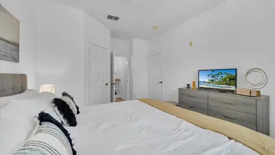 a bedroom with a bed and a tv on a dresser at BF 2Bedrooms 2303 - 102 in Kissimmee