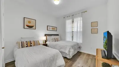 a bedroom with two beds and a tv in it at BF 2Bedrooms 2303 - 102 in Kissimmee