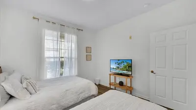 a bedroom with two beds and a flat screen tv at BF 2Bedrooms 2303 - 102 in Kissimmee