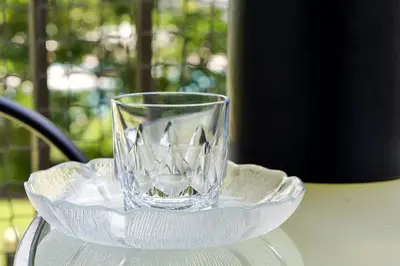 a glass sitting on a plate on a table at 6165 CARRIER DR #1212 ORLANDO 1BED in Orlando