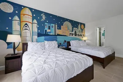 a bedroom with two beds and a mural of rockets at 6165 CARRIER DR #1212 ORLANDO 1BED in Orlando
