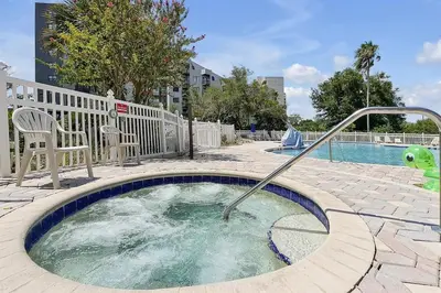 a small pool with a hot tub in a yard at 6165 CARRIER DR #1212 ORLANDO 1BED in Orlando