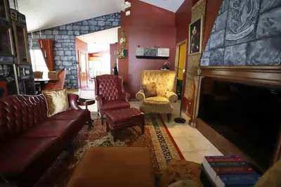 a living room with a couch and chairs and a fireplace at Magical 5-Bedroom Villa Near Universal's Wizarding World in Kissimmee