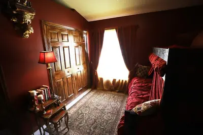 a room with a window and a couch and a lamp at Magical 5-Bedroom Villa Near Universal's Wizarding World in Kissimmee