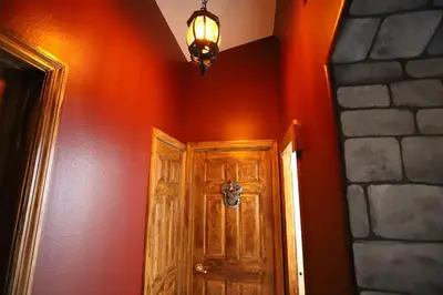 a hallway with a wooden door and a light at Magical 5-Bedroom Villa Near Universal's Wizarding World in Kissimmee