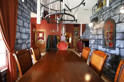 a dining room with a wooden table and chairs at Magical 5-Bedroom Villa Near Universal's Wizarding World in Kissimmee