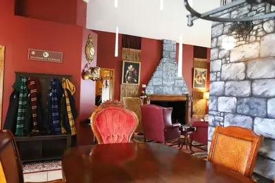 a dining room with a table and a fireplace at Magical 5-Bedroom Villa Near Universal's Wizarding World in Kissimmee