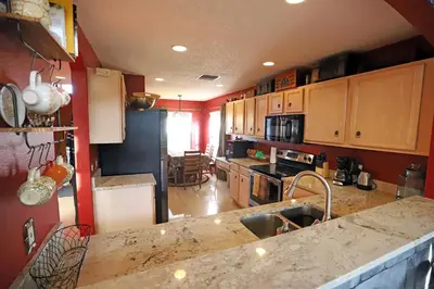 a kitchen with red walls and a counter top at Enchanted Villa with Lake View 6-Bedroom in Resort 9 miles to Disney World 15 miles to the Wizarding World of Harry Potter in Kissimmee