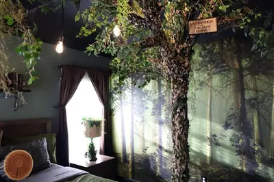 a bedroom with a tree mural on the wall at Enchanted Villa with Lake View 6-Bedroom in Resort 9 miles to Disney World 15 miles to the Wizarding World of Harry Potter in Kissimmee