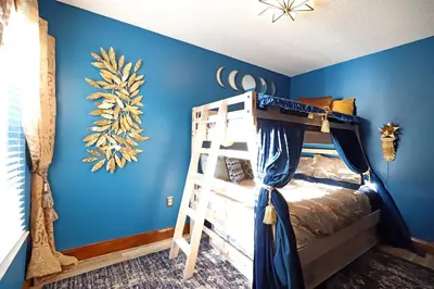 a bedroom with blue walls and a bunk bed at Enchanted Villa with Lake View 6-Bedroom in Resort 9 miles to Disney World 15 miles to the Wizarding World of Harry Potter in Kissimmee
