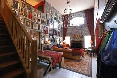 a living room with a large wall of pictures at Waterfront 6-Bedroom Wizarding Villa in Lake Berkley Near Universal Studio's Harry Potter in Kissimmee