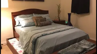a bedroom with a large bed with two pillows on it at Home Near Disney Private Pool & Playground in Howey in the Hills