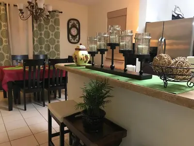 a dining room with a table and a counter top with a tableablish at Home Near Disney Private Pool & Playground in Howey in the Hills