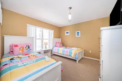 a childs bedroom with two beds and a window at Family-Friendly 5-Bedroom Home With Pool Near Disney in Orlando