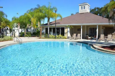 a large swimming pool in front of a house at Villa Port - Lucaya Village in Kissimmee