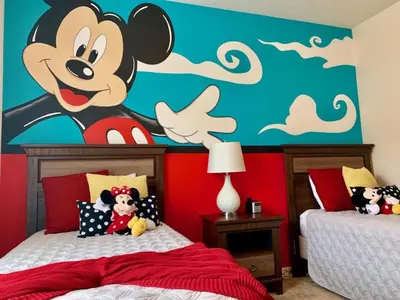 a bedroom with a mickey mouse mural on the wall at Villa Magic- Lucaya Villa Resort in Kissimmee