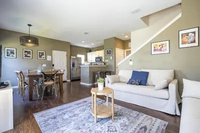 a living room with a white couch and a table at Villa Hakuna Matata- Lucaya Village Resort in Kissimmee