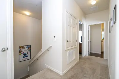 a hallway of a home with white walls and a staircase at Villa Hakuna Matata- Lucaya Village Resort in Kissimmee
