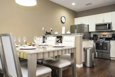 a kitchen with a table and chairs in a kitchen at Villa Coelho - West Lucaya Resort in Kissimmee