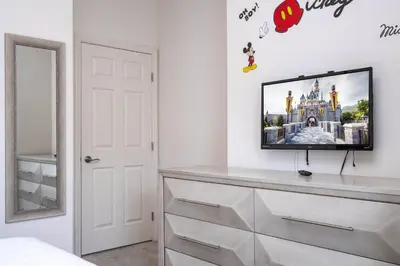 a bedroom with a flat screen tv on a dresser at Villa Coelho - West Lucaya Resort in Kissimmee