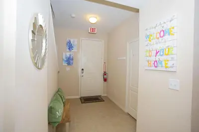a hallway with a white door and a mirror at Villa Compass- Compass Bay in Kissimmee