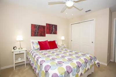 a bedroom with a bed and a ceiling fan at Villa Compass- Compass Bay in Kissimmee
