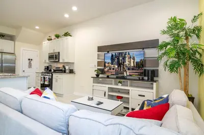a living room with two couches and a tv at Magic Villa Orlando in Orlando