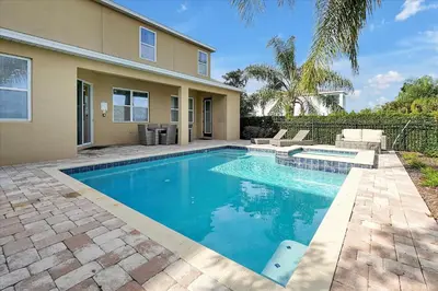 a swimming pool in front of a house at 261 LASSO DRIVE 6BED in Orlando