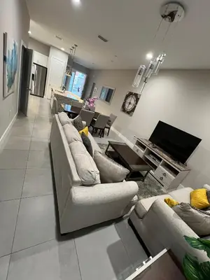a living room with couches and a dining room at Disney here we go in Orlando
