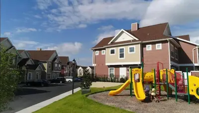 a playground in a residential neighborhood with houses at Disney here we go in Orlando