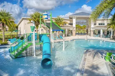a swimming pool with a slide in a resort at 2476 SHANTI DRIVE 12BED in Kissimmee