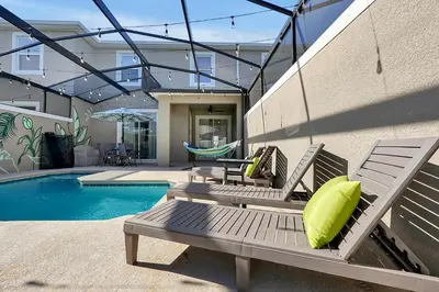 a patio with two chairs and a pool at Top Rated 4BR home in Kissimmee