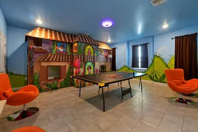 a room with a ping pong table in front of a house at 2968 PENELOPE LOOP 10 BED in Kissimmee