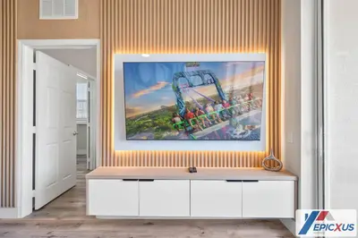 a living room with a painting on the wall at The Epic Cork Vista Cay Orlando in Orlando