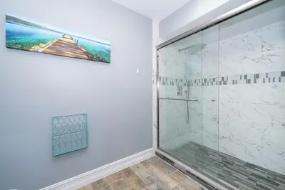a bathroom with a shower with a glass door at 4820 JAMAICA LANE 4BED in Kissimmee