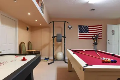 a room with a pool table and an american flag at Veranda Palms Villa: Pool, Spa & Game Room in Kissimmee