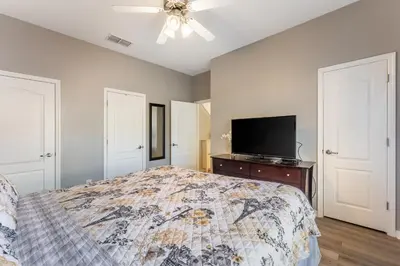 a bedroom with a bed and a flat screen tv at 4BR Retreat with Resort Access and Pool in Kissimmee