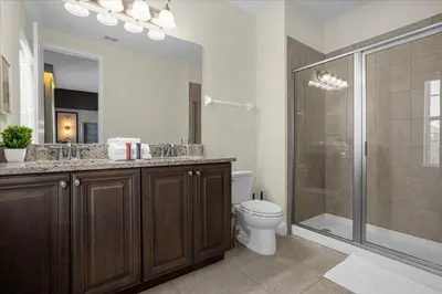 a bathroom with a toilet and a glass shower at Awsome 8 Bd 6.5 Ba Sleeps 20 Encore in Orlando