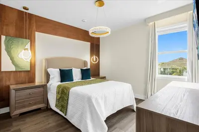 a bedroom with a bed and a window at Awsome 8 Bd 6.5 Ba Sleeps 20 Encore in Orlando