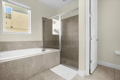 a bathroom with a shower and a bath tub at Awsome 8 Bd 6.5 Ba Sleeps 20 Encore in Orlando