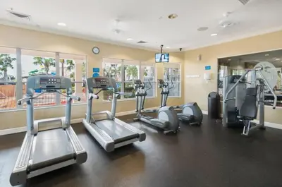 a gym with several treadmills and elliptical machines at Windsor Hills Getaway: 3BR, Pool, Near Disney in Orlando