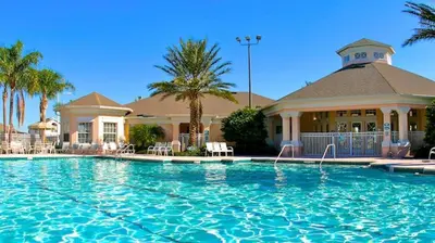 a large swimming pool in front of a house at Your Cozy 3 BD Home w Private Hot Tub & BBQ Gril in Kissimmee